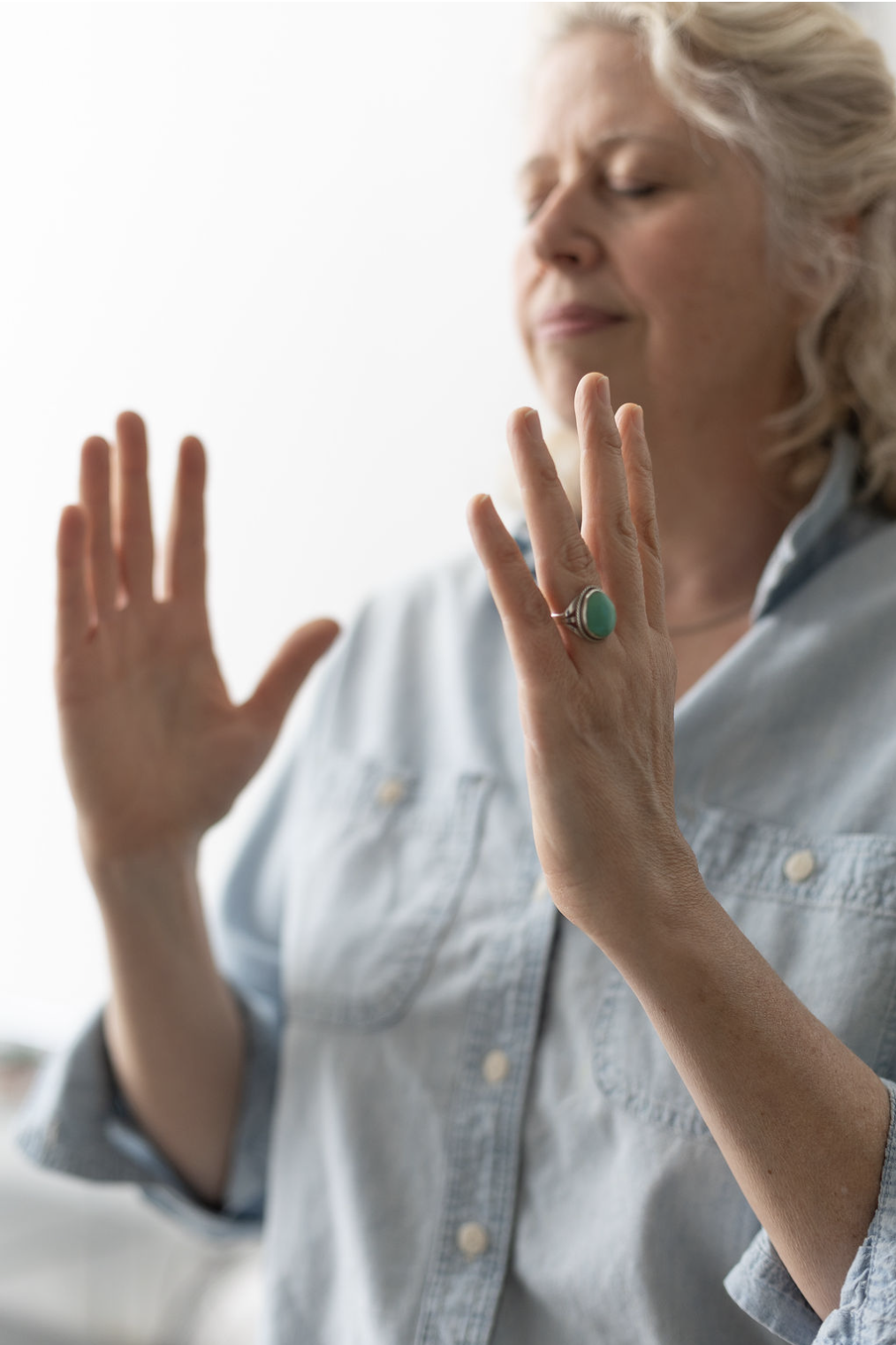 Hands holding space during an energetic release session